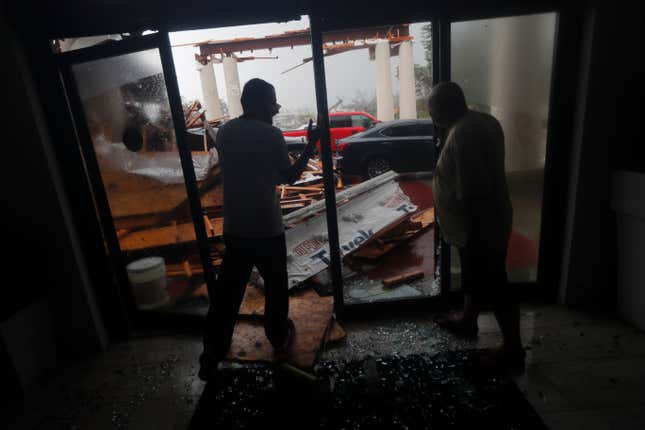 Hotel employees in Panama City Beach survey damage caused by the hurricane.