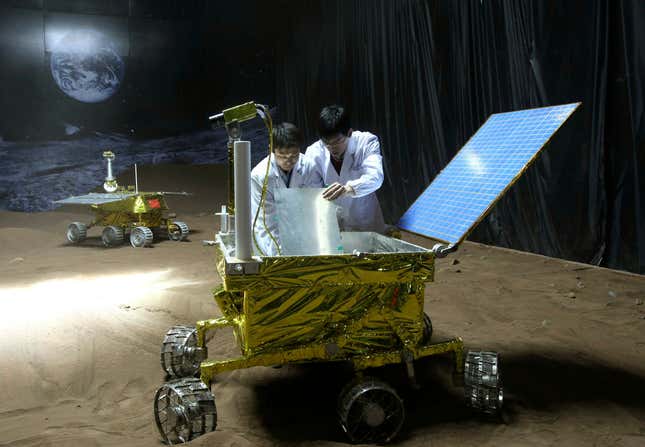 Researchers from the Shanghai Academy of Spaceflight Technology check a prototype lunar rover in 2008.