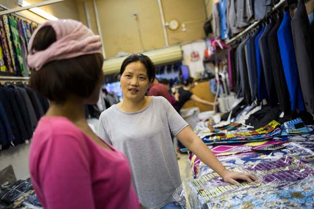 Maliya Lu helps a customer look for fabric at her store in China City Wholesale centre in Doornfontein, Johannesburg. Lu specialises in importing suits and other fabrics from China and Africa. She has had the store for 14 years and says "we are OK at the moment, the economy is not too bad for us". China City is a development near the CBD in Johannesburg and has clientele from all across the greater city.
