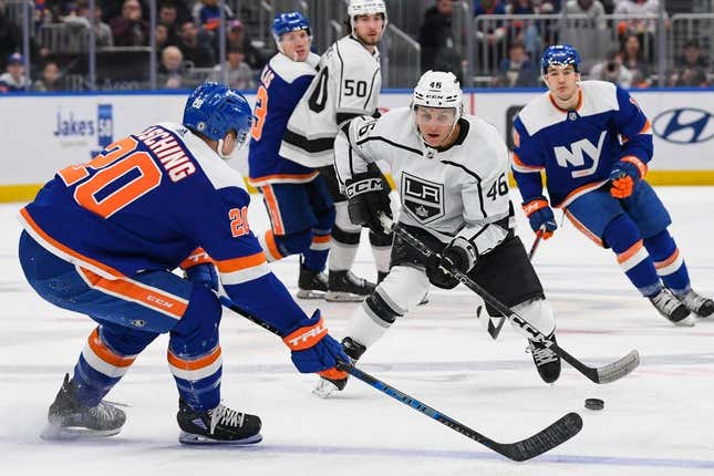 Feb 24, 2023; Elmont, New York, USA;  Los Angeles Kings center Blake Lizotte (46) state across the blue line defended by New York Islanders right wing Hudson Fasching (20) during the first period at UBS Arena.