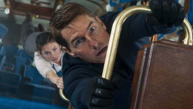 A photo shows Tom Cruise dangling in a train as seen in the new Mission Impossible.