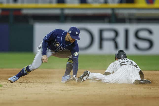 Apr 28, 2023; Chicago, Illinois, USA; Chicago White Sox left fielder Andrew Benintendi (23) steals second base against Tampa Bay Rays second baseman Brandon Lowe (8) during the seventh inning at Guaranteed Rate Field.
