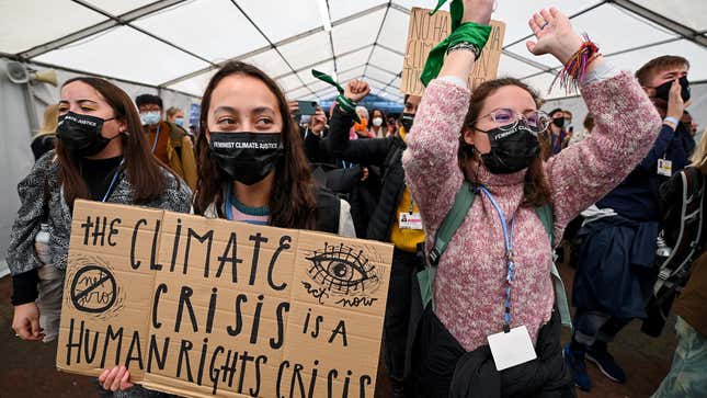 Protesters move through restricted Blue Zone area of COP26 climate summit.