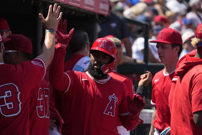 Mar 25, 2023; Tempe, Arizona, USA; Los Angeles Angels second baseman Luis Rengifo (2) celebrates with teammates after scoring against the Chicago Cubs in the third inning at Tempe Diablo Stadium.