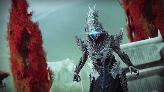 A giant monster with three blue eyes stands menacingly in front of red trees in Destiny 2: The Witch Queen, one of the best shooters of 2022.