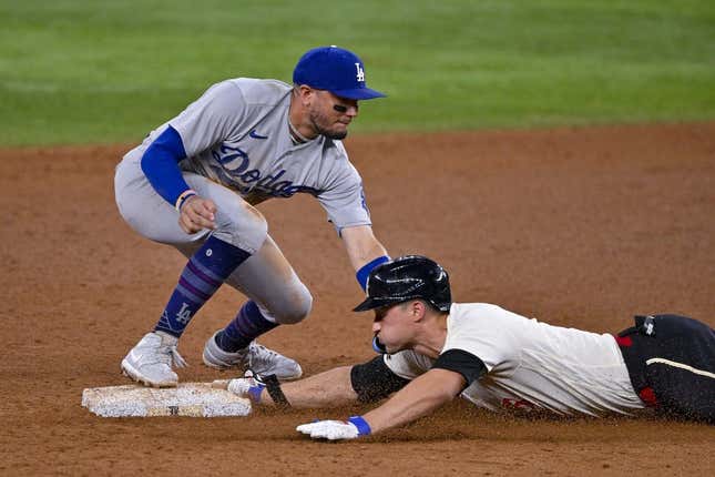 Jul 21, 2023; Arlington, Texas, USA; Texas Rangers shortstop Corey Seager (5) slides under the throw to Los Angeles Dodgers shortstop Miguel Rojas (11) at second base during the eighth inning at Globe Life Field.