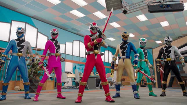 The Dino Fury Power Rangers strike a pose in what appears to be a lobby..?