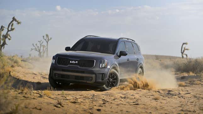A photo of a 2023 Kia Telluride driving on dust. 