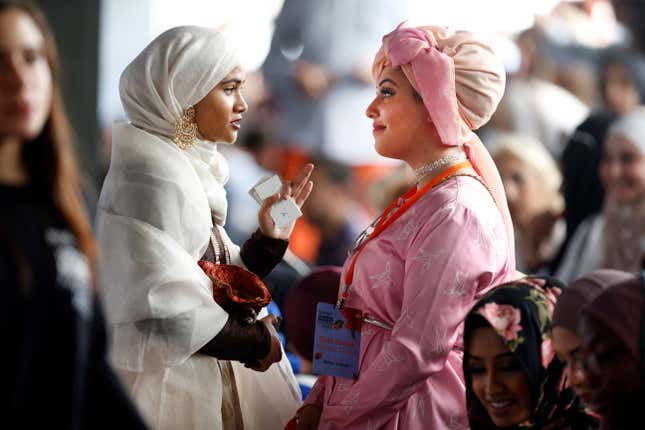 Fashion enthusiasts talk ahead of the launch fashion show during the International Modest Fashion Week, in Istanbul, Friday, May 13, 2016. Turkeys first International Modest Fashion Week has opened in Istanbul bringing designers and models of conservative wear from around the world. The two-day event kicked off Friday with models hitting the runway at a historic train station donning a bright palette of breezy garment and kaleidoscopic headscarves. (AP Photo/Lefteris Pitarakis)