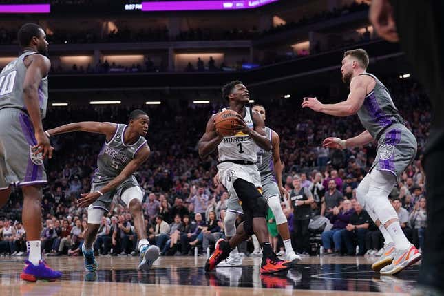 Mar 27, 2023; Sacramento, California, USA; Minnesota Timberwolves guard Anthony Edwards (1) drives to the hoop between Sacramento Kings guard De'Aaron Fox (5) and forward Domantas Sabonis (10) in the second quarter at the Golden 1 Center.