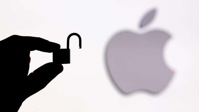 A hand holding a tiny lock in front of the Apple logo