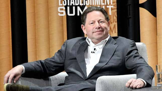 Bobby Kotick sits in a chair, smirking.