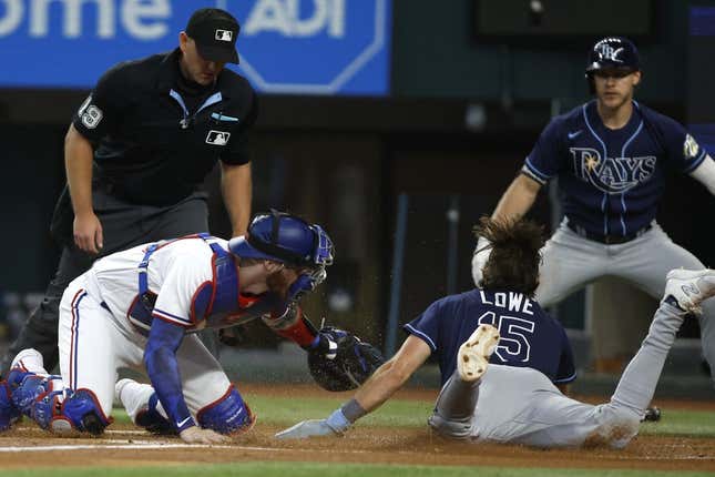 Jul 19, 2023; Arlington, Texas, USA; Texas Rangers catcher Jonah Heim (28) tags Tampa Bay Rays designated hitter Josh Lowe (15) out at home plate in the second inning at Globe Life Field.