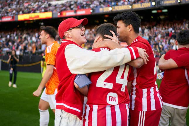 Aniquiladores president Juan Guarnizo hugs members of his team at the Kings League final.