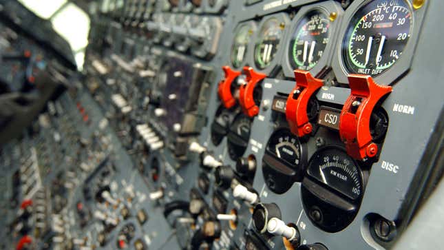 A photo of the controls in an airplane cockpit. 