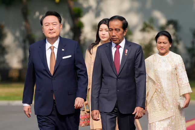 South Korean President Yoon Suk Yeol, left, and his wife Kim Keon Hee, rear left, walk with Indonesian President Joko Widodo and his wife Iriana upon arrival for their meeting at Merdeka Palace in Jakarta, Indonesia, Friday, Sept. 8, 2023. (AP Photo/Achmad Ibrahim)