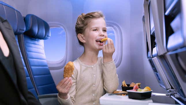 Child eating kids menu food on United Airlines flight