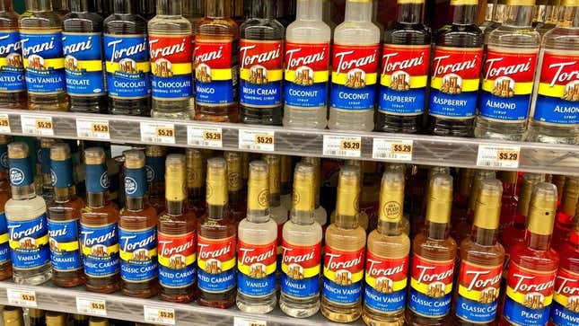 Torani syrup bottles on shelf