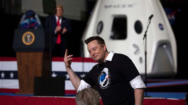 Elon Musk is shown making a hand gesture in front of a SpaceX rocket.