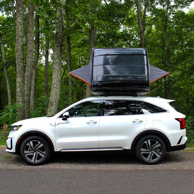 A photo of the back of a Roofnest Condor tent showing its hard top and two window shrouds.