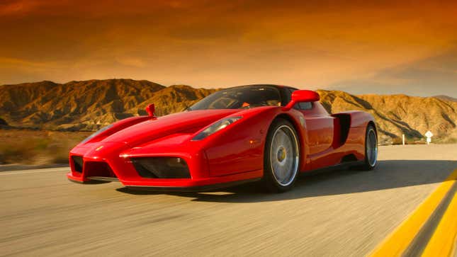 A red Ferrari Enzo driving on a highway. 