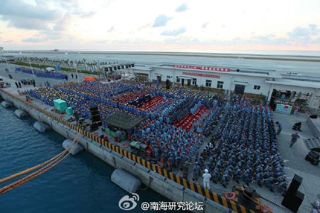 The audience gathers on Fiery Cross Reef in the Spratly archipelago.