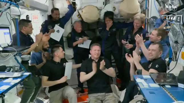 Mission specialist Rayyanah Barnawi, representing Saudi Arabia, reacts after she was given a pin as the 600th astronaut by Axiom Mission 2 (Ax-2) Commander Peggy Whitson after their crew's arrival on the International Space Station orbiting Earth May 22, 2023 in a still image from vide