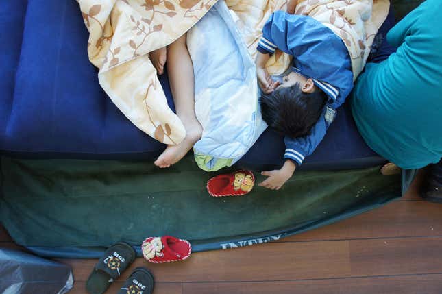 Image for article titled Photos: A family of Kurdish refugees is living in a Moscow airport lounge
