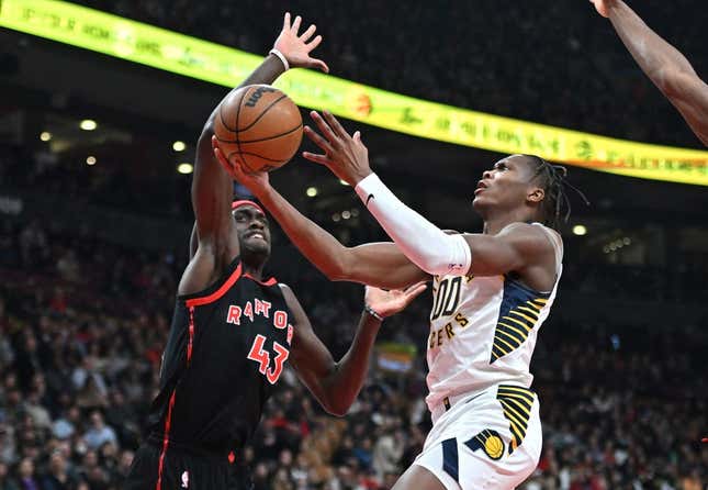 Mar 22, 2023; Toronto, Ontario, CAN;  Indiana Pacers forward Bennedict Mathurin (00) shoots the ball as Toronto Raptors forward Pascal Siakam (43) defends in the first half at Scotiabank Arena.