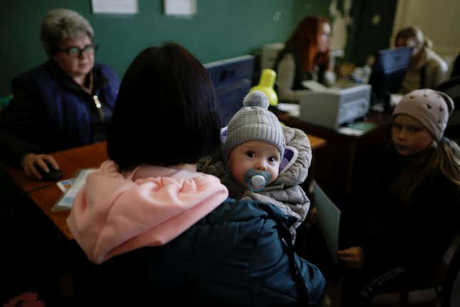A Ukrainian woman holds her baby while at a refugee centre for internally displaced people to collect aid and register, amid Russia's invasion of Ukraine, in the town of Kryvyi Rih, Dnipropetrovsk region, Ukraine April 25, 2022.