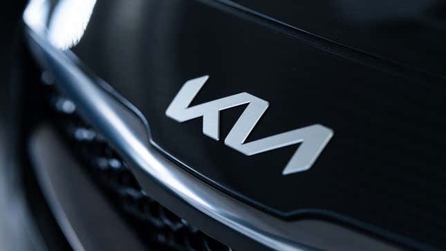 A photo of a Kia logo on a car. 