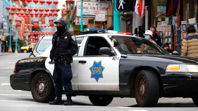 SAN FRANCISCO, CALIFORNIA - MARCH 17: A San Francisco police officer stands guard on Grant Avenue in Chinatown on March 17, 2021 in San Francisco, California. 