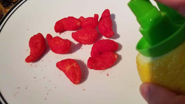 spraying puffy cheetos with lemon