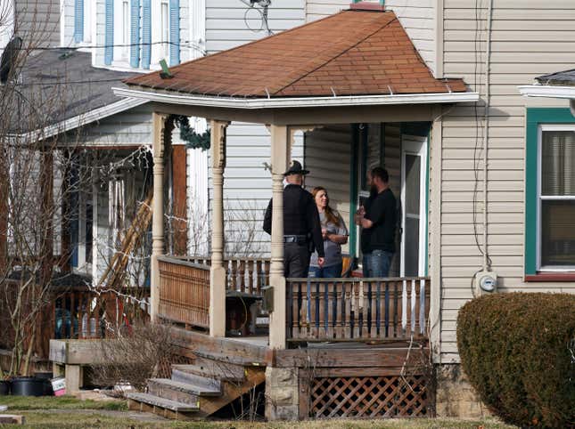 An Ohio state trooper goes door to door telling residents to leave downtown East Palestine, Ohio, on Sunday, Feb. 5, 2023.