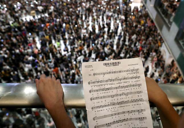 A participant holds sheet music of Hong Kong's protest anthem during a protest in 2019.