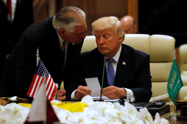Tillerson hands Trump a note in Riyadh, Saudi Arabia.