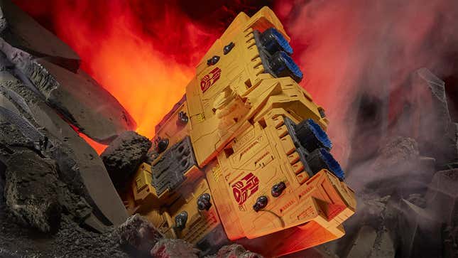 An image of the Transformers toy Ark crashed into a faux volcano. 