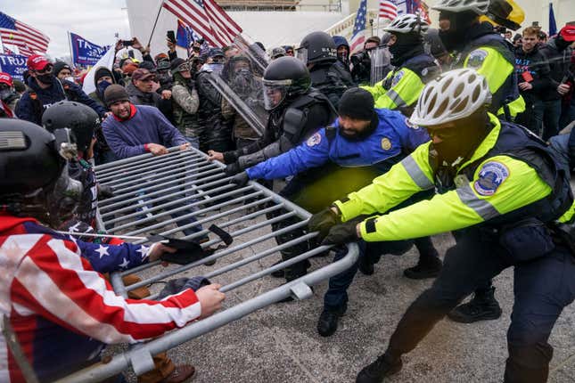 In this Jan. 6, 2021, file photo violent insurrectionists loyal to President Donald Trump hold on to a police barrier at the Capitol in Washington. 