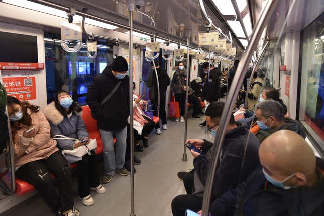 People wear masks to travel on a subway in Nanjing, Jiangsu province, China, Dec 6, 2022.
