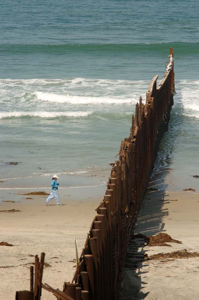 Edge of the border wall stretches to the Pacific Ocean.