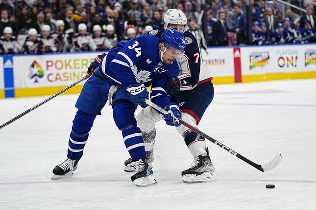 Apr 4, 2023; Toronto, Ontario, CAN; Toronto Maple Leafs forward Auston Matthews (34) gets held up by Columbus Blue Jackets forward Sean Kuraly (7) during the first period at Scotiabank Arena.
