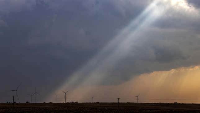 Sunlight filters through storm clouds onto a wind turbine as severe weather rolls through the midwest on Tuesday, April 4, 2023, south of Stuart, Iowa. 