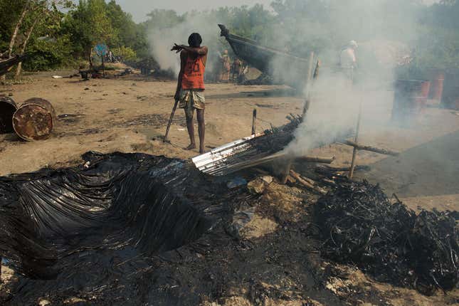 The collected plant matter is heated in what looked like corrugated tin sheets to loosen the oil.