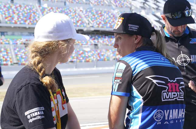 Paris (right) talking with rider Kayla Yaakov (left) at Daytona International Speedway.