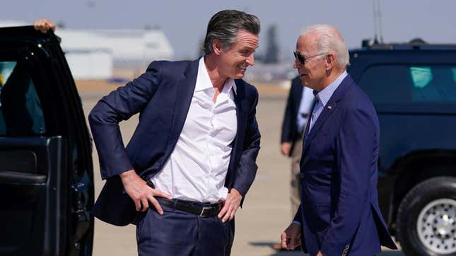President Joe Biden talks with California Gov. Gavin Newsom as he arrives at Mather Airport on Air Force One Monday, Sept. 13, 2021.
