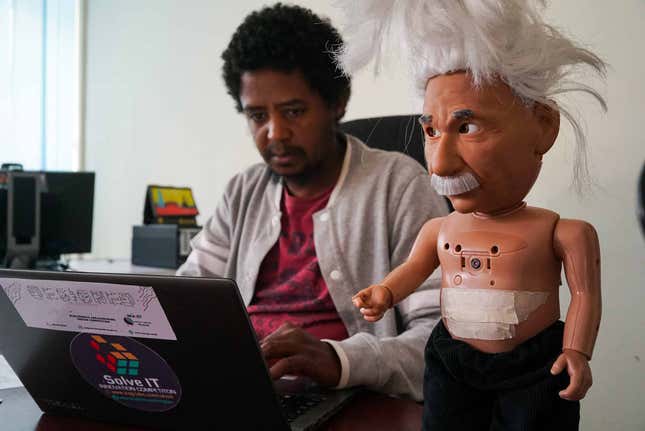 Getnet Assefa works at iCog Labs with a ‘Robo-Einstein’ at his side.
