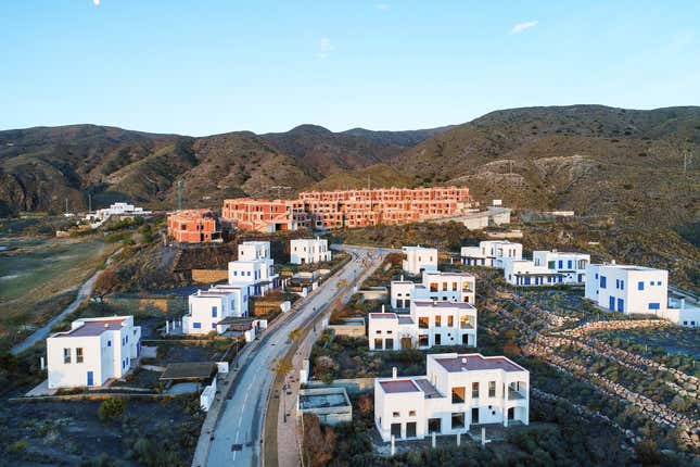 An aerial view of a partially built housing development.
