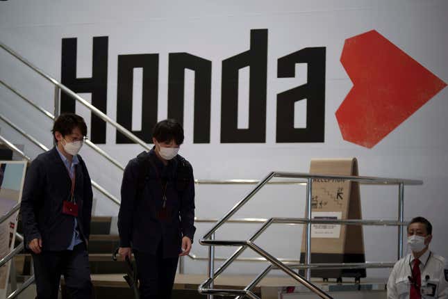 FILE - People walk near the logo of Honda Motor Company at a showroom in Tokyo, May 13, 2022. Honda reported Wednesday, Aug. 9, 2023, that its April-June profit more than doubled on healthy sales of its motorcycles and cars, as the Japanese company also received a perk from favorable exchange rates. (AP Photo/Eugene Hoshiko, File)