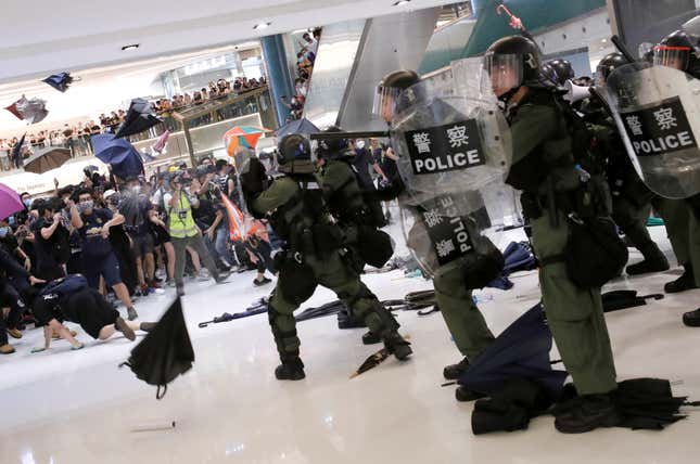 Riot police use pepper spray to disperse protesters inside a shopping mall in Hong Kong, July 14, 2019.