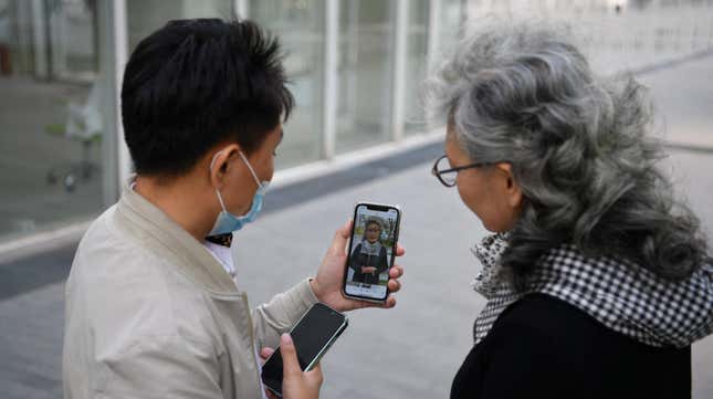 Chinese social media influencer and grandmother Ruan Yaqing, right, and her assistant Xie Xincun, left, reviewing a video intended for her channels on short-form video apps Kuaishou and Douyin in Beijing in April 2021.